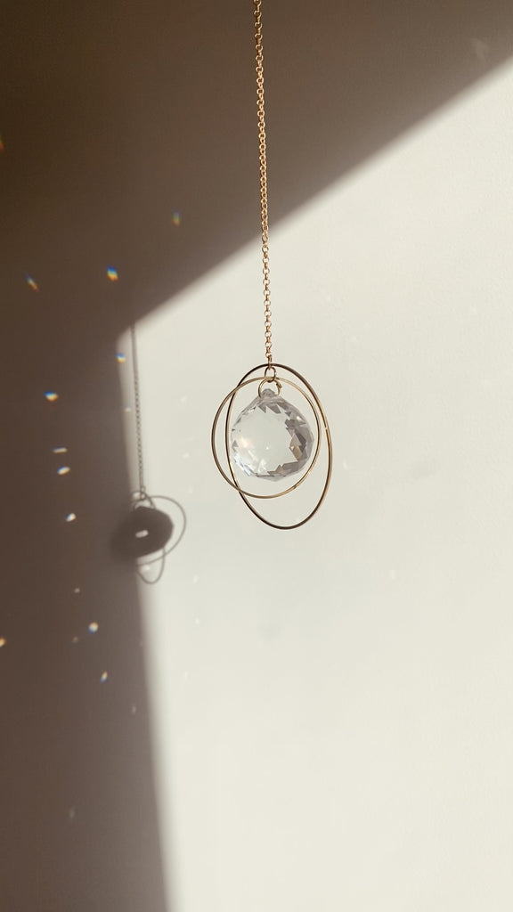 Video of hanging Crystal Suncatcher making rainbows - Universe Medium